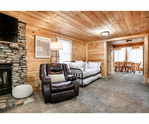 a living room with a couch and a chair at City Hideaway - Hot Tub, Fireplace, Grill in Gatlinburg