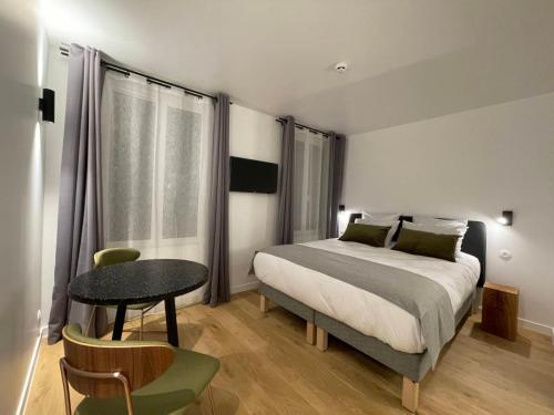 Postel nebo postele na pokoji v ubytování Appart Hôtel Victoria