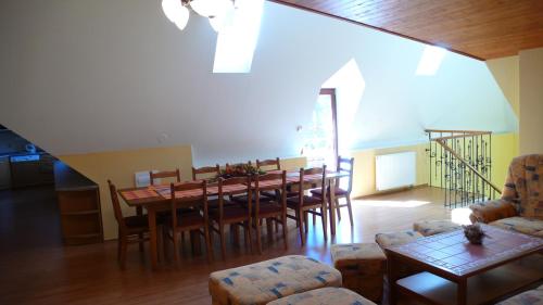 a dining room with a table and chairs at Penzion Padrtův mlýn in Třebíč