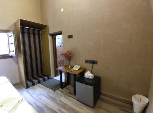 a room with a desk and a phone on a wall at Omani House Inn نزل البيت العماني in Nizwa