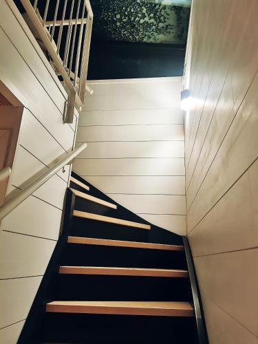 a staircase in a building with black and brown steps at Levi Sky Igloo with private sauna and hot tub in Levi