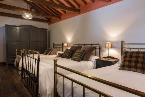 Un pat sau paturi într-o cameră la Casa Cuqui