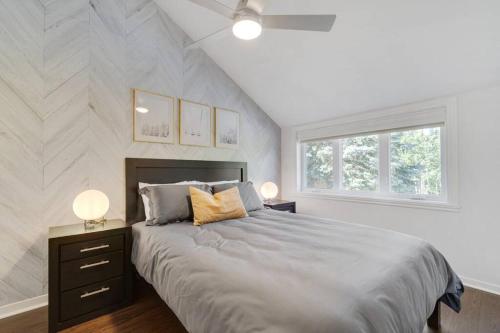 a bedroom with a large bed and two lamps at INITIAL - ZÉPHYR - Mont-Sainte-Anne in Beaupré