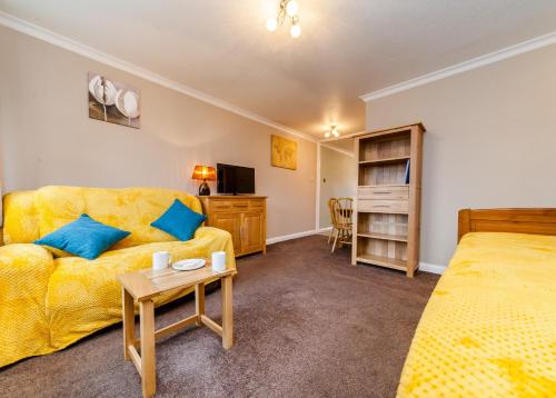 a living room with a couch and a bed at Sawyers Lodge in Burgess Hill