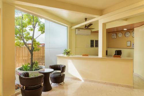 a kitchen with a table and chairs and a tree at One On Inn Maldives in Maradhoofeydhoo