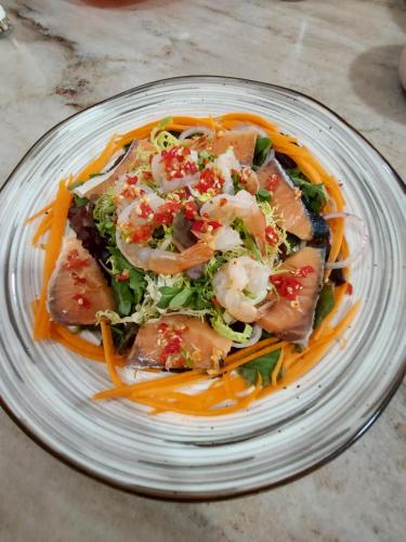 a plate of food with shrimp and vegetables on it at Palms Retreat in Fulhadhoo