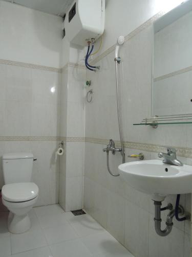 a bathroom with a toilet and a sink at Hai Trang Hotel in Ha Long