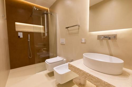 a bathroom with a sink and a toilet at Double A Luxury Room in Olbia