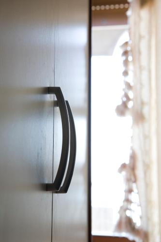 a close up of a door with a handle on a cabinet at Residence Le Terrazze Sul Mare in San Mauro a Mare