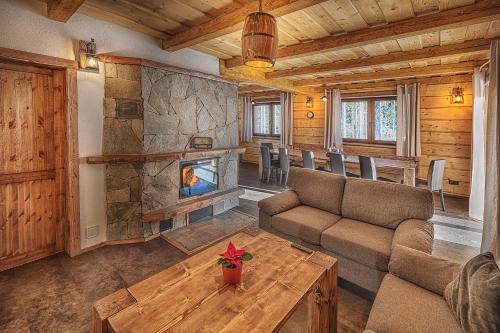 a living room with a couch and a fireplace at Chata Líška JASNA in Liptovský Mikuláš