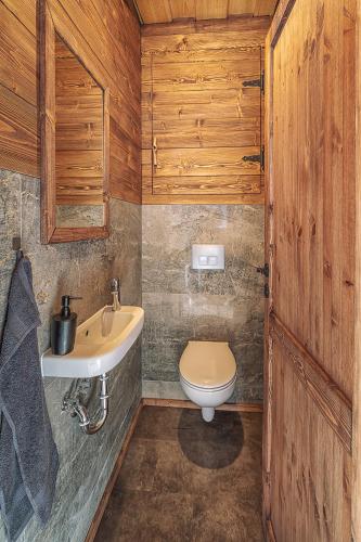a bathroom with a toilet and a sink at Chata Líška JASNA in Liptovský Mikuláš