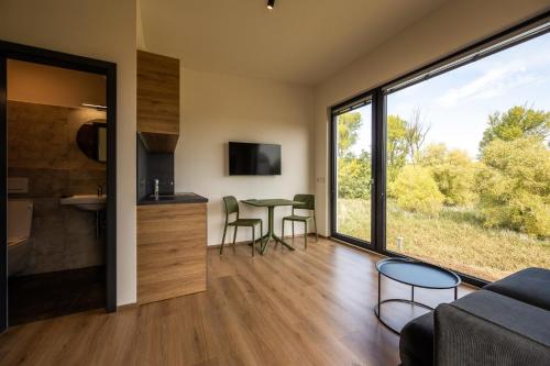 a living room with a couch and a table with chairs at Na Zeleném statku in Rašovice