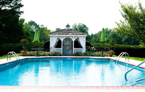 a swimming pool with a gazebo in a yard at Antrim 1844 in Taneytown