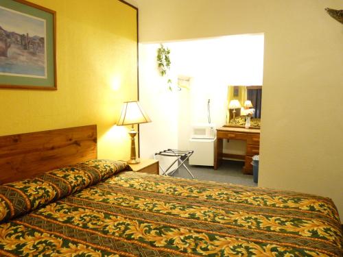 A bed or beds in a room at Supai Motel