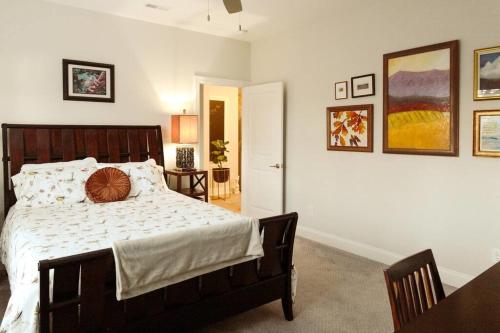 a bedroom with a large bed and a dining room at The Nest in 5 Points, Downtown, Walk to Everything in Huntsville