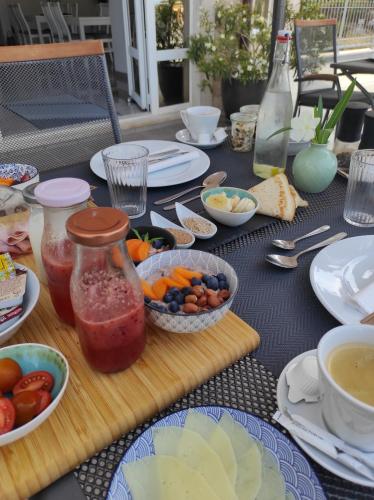 a table with plates and bowls of food on it at White Stone Villa 43 in Promajna