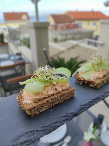 two pieces of food sitting on a table at White Stone Villa 43 in Promajna