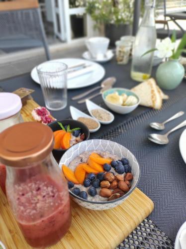 a table topped with a bowl of fruits and vegetables at White Stone Villa 43 in Promajna
