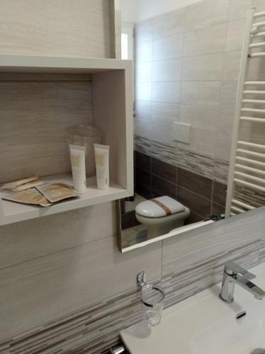 a bathroom with a sink and a mirror and a toilet at B&B Albachiara in Senise