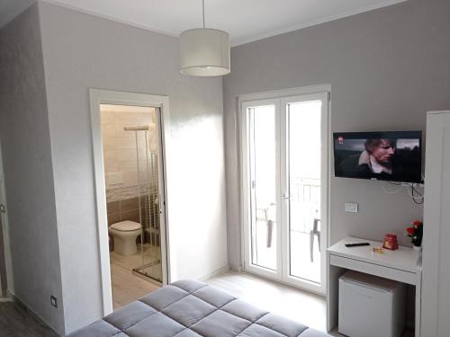 a living room with a couch and a sliding glass door at B&B Albachiara in Senise