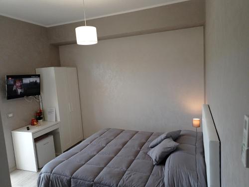 a bedroom with a bed and a tv on a wall at B&B Albachiara in Senise