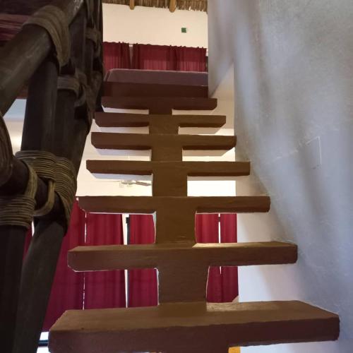 a group of wooden stairs in a building at Villa del Mar in Zipolite
