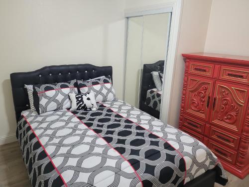 a bedroom with a bed and a red dresser at Adorable 1 bedroom Apartment in Vallejo