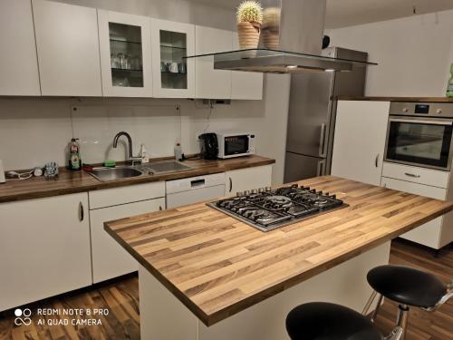 a kitchen with a wooden counter top and a stove at Sky Night Guest House in Düren - Eifel