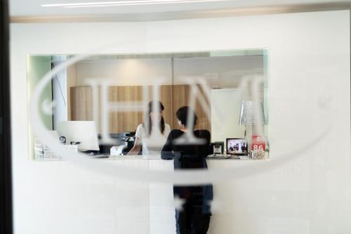 a reflection of a woman in a mirror at Hotel Minerva in Siena