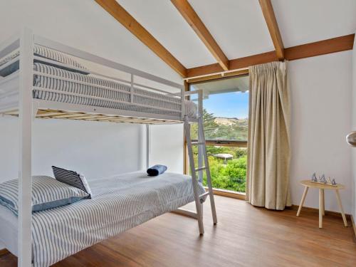 a bedroom with a bunk bed and a window at SeaEsta 10 Lewis Road Carrickalinga in Carrickalinga
