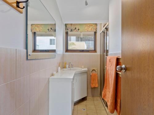 a bathroom with a sink and a mirror at SeaEsta 10 Lewis Road Carrickalinga in Carrickalinga