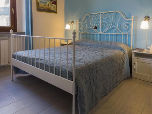 a bedroom with a bed with a blue headboard at Petali di Toscana in Nugola