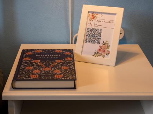 a book sitting on a table next to a box at Petali di Toscana in Nugola