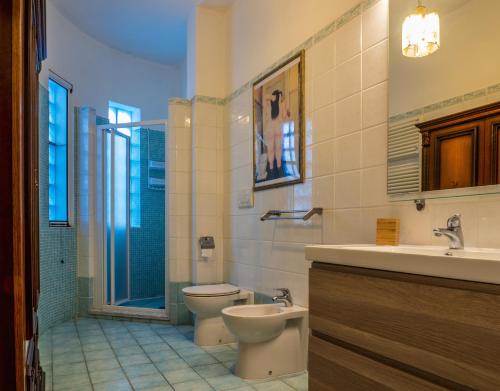 a bathroom with a toilet and a sink and a shower at Petali di Toscana in Nugola