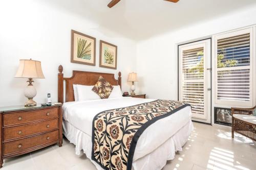 a bedroom with a bed and a dresser and a window at K B M Resorts KBV-28G2 - Expansive 1500ft retreat, large balcony, jaw-dropping views, steps from beach in Kapalua