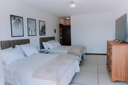 A bed or beds in a room at Pousada Peninsula de Buzios
