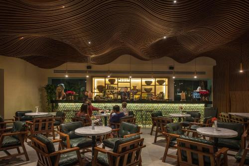 a restaurant with tables and chairs and a bar at Ventus Ha at Marina El Cid Spa & Beach Resort - All Inclusive in Puerto Morelos