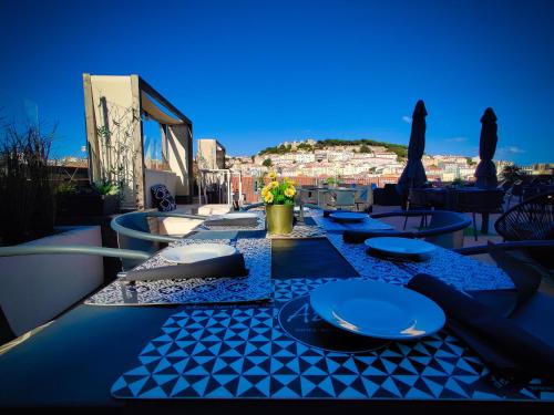 a blue table with plates and napkins on a balcony at The ART INN Lisbon in Lisbon