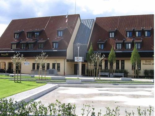 a large building with a courtyard in front of it at Hotel Hembacher Hof in Rednitzhembach