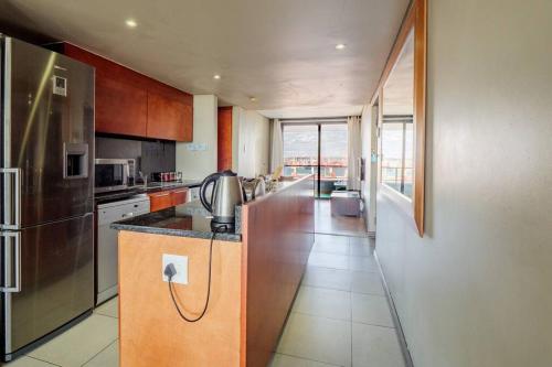 a kitchen with a refrigerator and a counter top at Executive apartment at Ushaka Marine in Durban