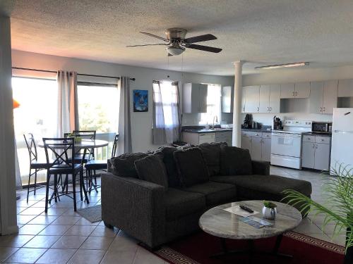 
a living room filled with furniture and a kitchen at Purple Sunset - Central Destin - 1BR Condo in Destin
