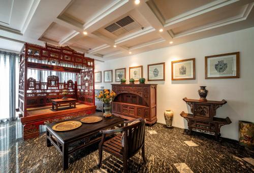 a dining room with a table and a fireplace at Amanaki Thao Dien in Ho Chi Minh City