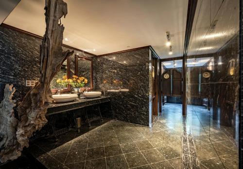a bathroom with two sinks and a glass wall at Amanaki Thao Dien in Ho Chi Minh City
