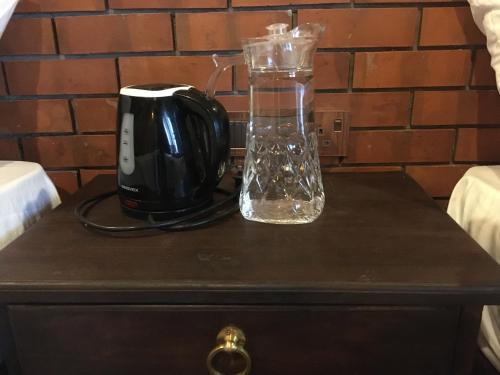 a glass blender on top of a table at Ceylon Resort in Wilpattu