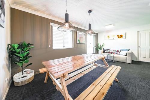a living room with a wooden bench and a couch at Calamvale Business or Holiday like Home in Brisbane