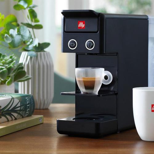 a coffee machine sitting on a table with a cup at Garden Wellness Hotel S in Andalo