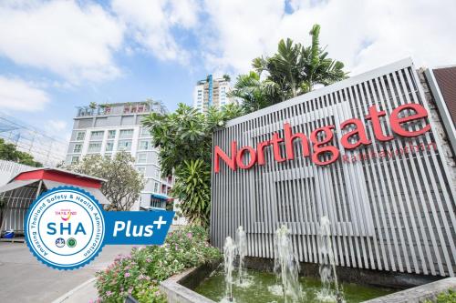 un panneau devant un hôtel avec une fontaine dans l'établissement Northgate Ratchayothin - SHA Extra Plus, à Bangkok