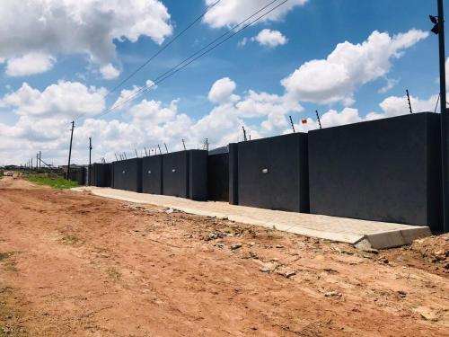 a fence on the side of a dirt road at RMB Luxury Lodge in Ga-Mothiba