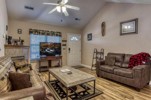 a living room with a couch and a tv at Rock of Ages, Hot Tub, Game Room, WIFI, Free Attraction Tickets, Near Parkway!!! in Pigeon Forge