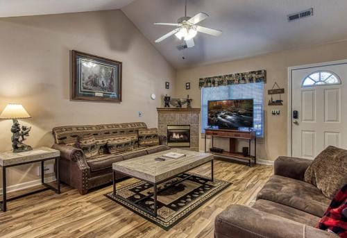 a living room with couches and a fireplace at Rock of Ages, Hot Tub, Game Room, WIFI, Free Attraction Tickets, Near Parkway!!! in Pigeon Forge